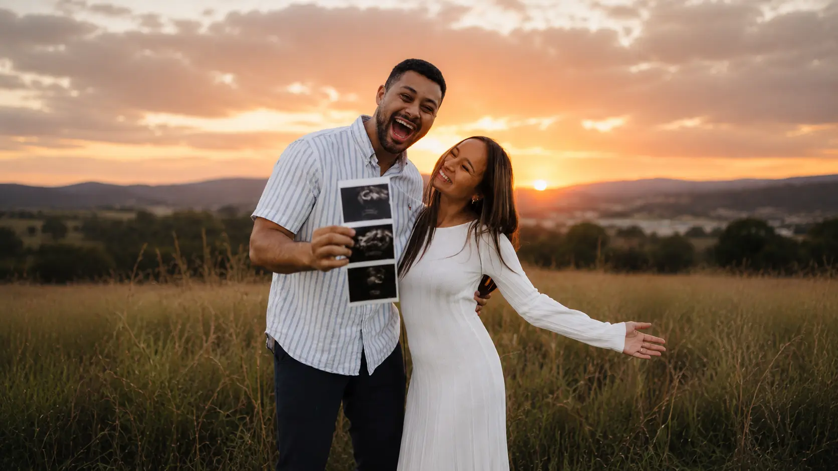 Gabriel and his wife holding their baby's ultrasound
