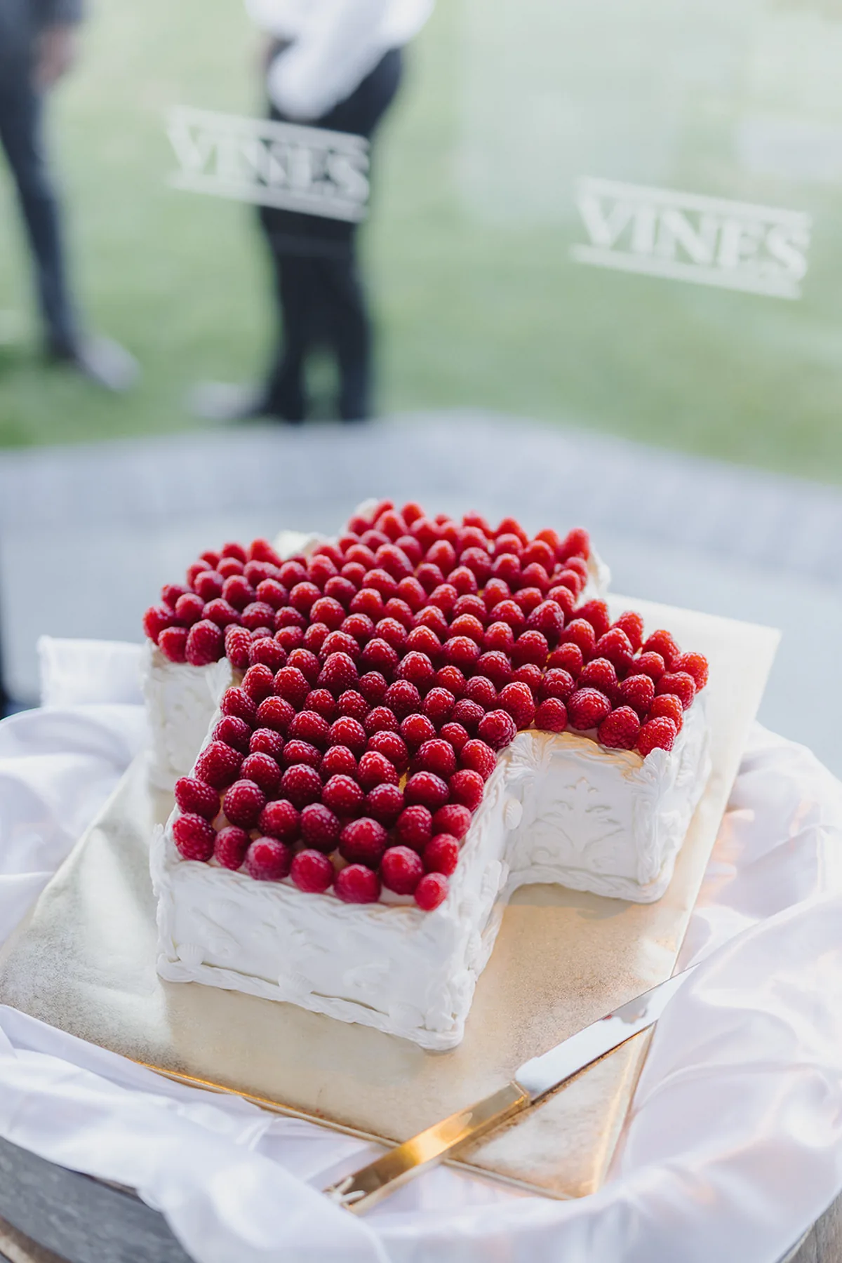 Wedding cake at Vines of the Yarra Valley, with the venue's signage visible behind