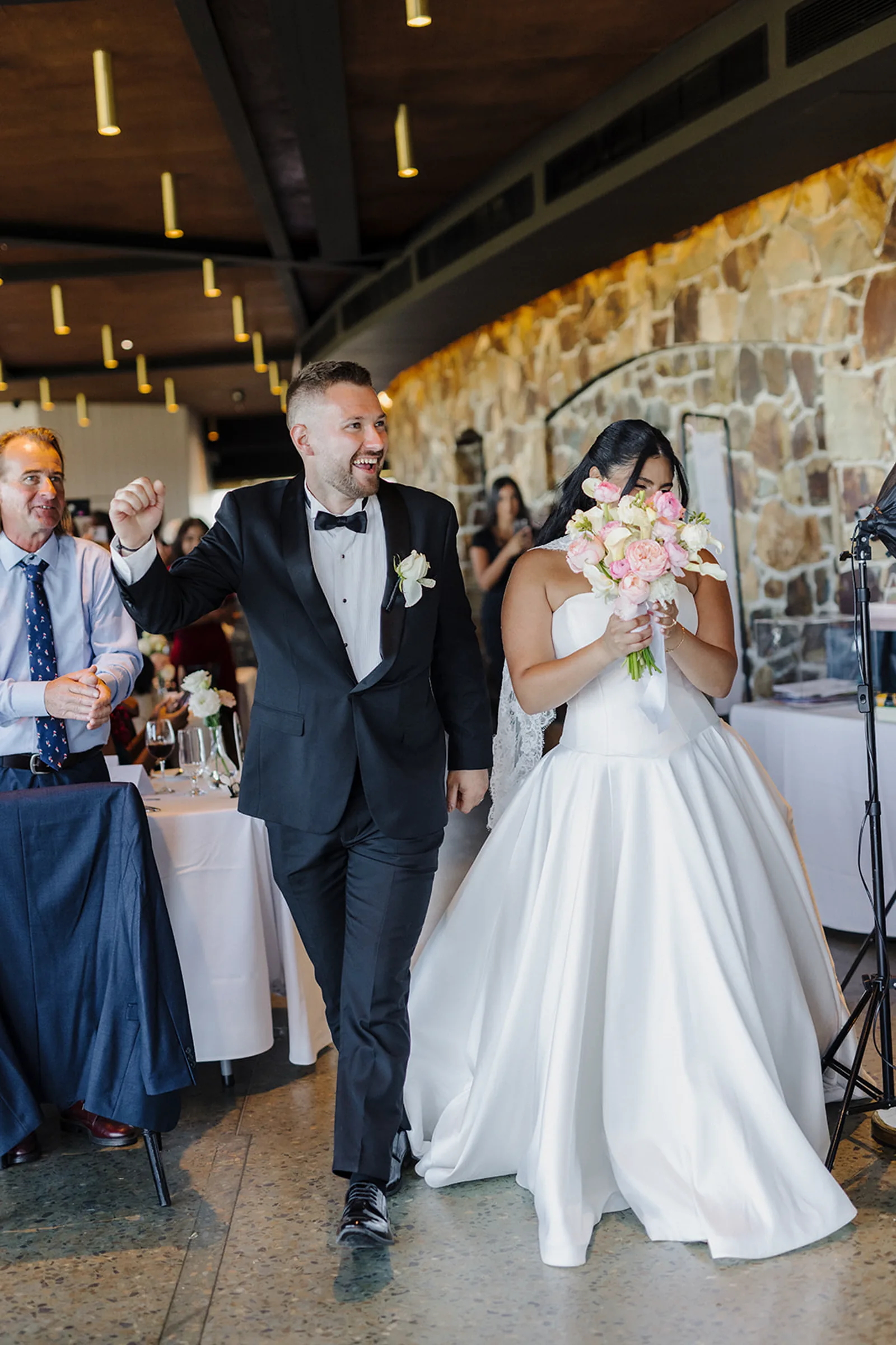 Sarah-Anna and Jesse entering the sandstone reception room at Vines of the Yarra Valley